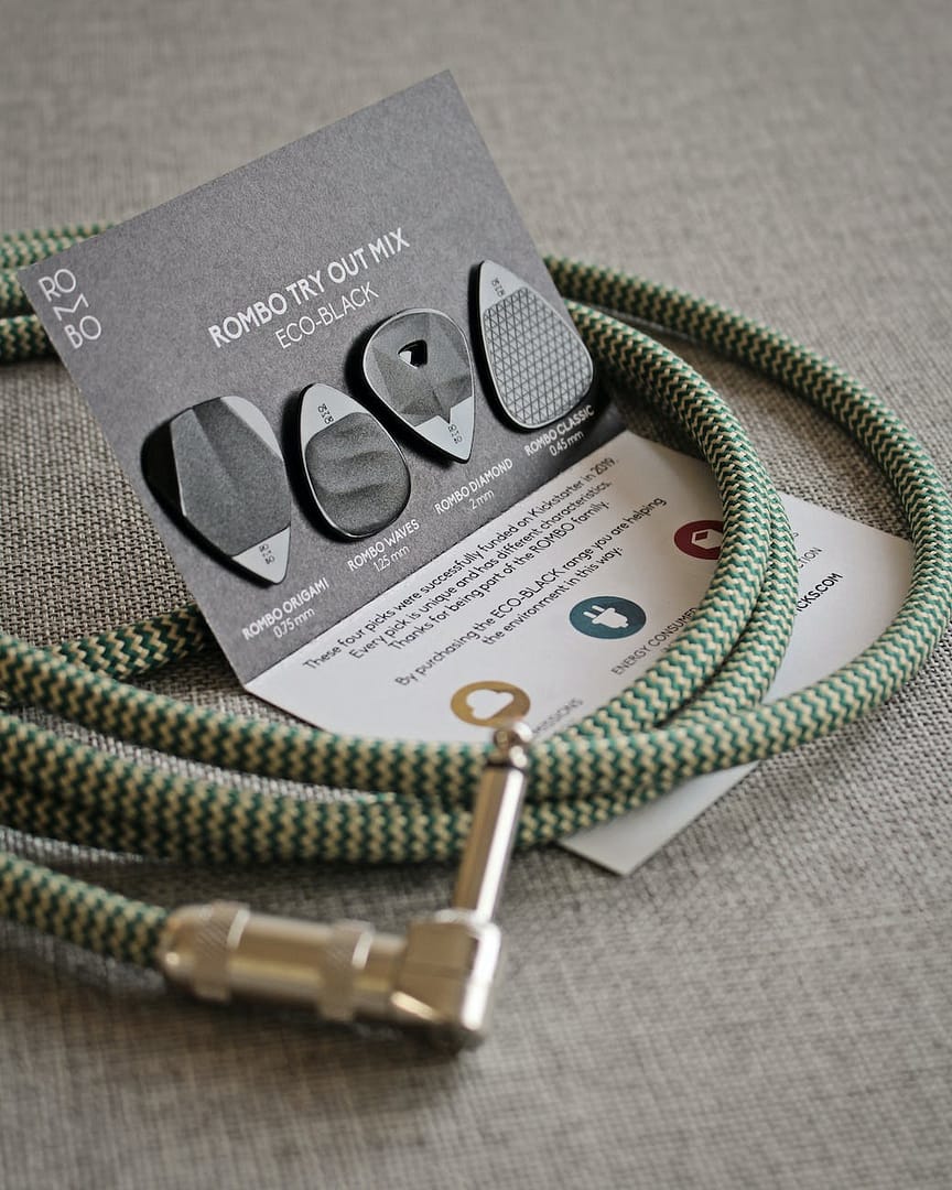 green chord and guitar picks on gray surface